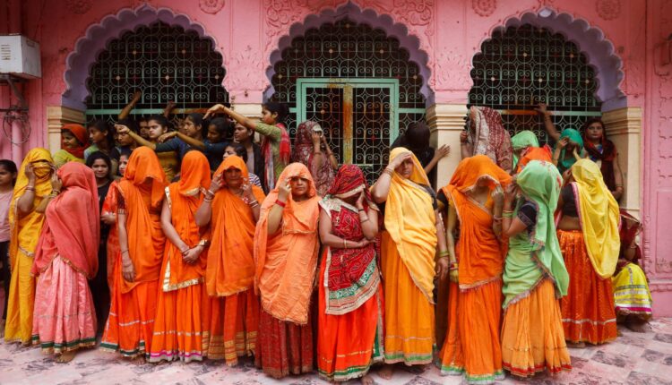 Women wait to take part in Huranga, a game played between men and women, a day after Holi at Dauji temple near the northern city of Mathura, India, on March 9.